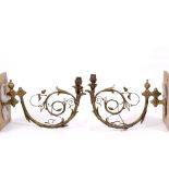 A PAIR OF VICTORIAN BRASS HINGED WALL LIGHTS with scrolling Gothic revival foliate decoration,