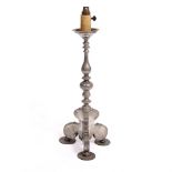 AN ANTIQUE DUTCH PEWTER PRICKET CANDLESTICK with turned stem and tripod base, later converted for