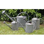 A LARGE ZINC SCHNEIDERKANNE 14 LITRE WATERING CAN 83cm in length, three further vintage watering