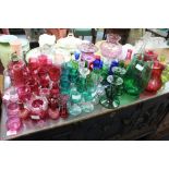A COLLECTION OF CRANBERRY AND OTHER GLASSWARE to include wine glasses, vases, an old lamp, a pair of
