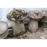 TWO ANTIQUE COTSWOLD STONE STADDLE STONES each with square tapering bases, approximately 62cm in