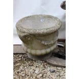 A MOULDED COMPOSITE STONE URN with ram's head, 45cm diameter x 40cm high