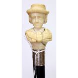 A VICTORIAN EBONY WALKING CANE with an ivory handle carved into the form of a lady or suffragette