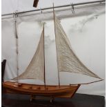 A MODEL SAILING BOAT with twin masts, 117cm long overall
