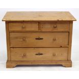 A PINE CHEST of two short and two long drawers with turned knob handles and raised on bracket