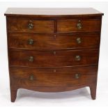 A VICTORIAN BOW FRONTED CHEST of two short and three long drawers with brass ring handles raised