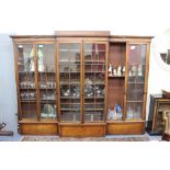 A 19TH CENTURY MAHOGANY BREAK FRONT BOOKCASE with two central glazed doors and two sliding doors