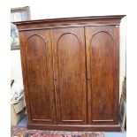 A VICTORIAN MAHOGANY TRIPLE WARDROBE the panel doors opening to reveal hanging space, linen slides