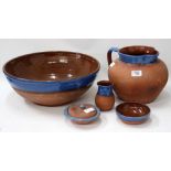 FOUR PIECES OF 20TH CENTURY BRANNAMWARE to include a wash bowl and jug, small pot and cover and