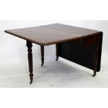 A 19TH CENTURY MAHOGANY DROP LEAF DINING TABLE with reeded legs and brass castors, the top 98cm x