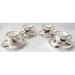 A SET OF FOUR 19TH CENTURY PORCELAIN TEA CUPS AND SAUCERS with hand painted decoration of exotic