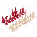 A 19TH CENTURY TURNED AND STAINED BONE CHESS SET the king 12cm in height