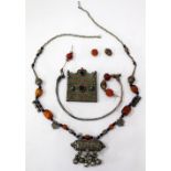 AN UNMARKED WHITE METAL ETHNIC BURBA, (POSSIBLY) AND ONE OTHER NECKLACE (2)