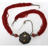 A 20TH CENTURY ETHNIC STYLE CORAL AND UNMARKED WHITE METAL NECKLACE the pendant formerly a scent