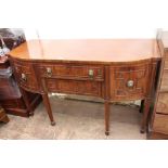 A 19TH CENTURY MAHOGANY SIDE BOARD with bow front and lion mask handles, standing on square tapering