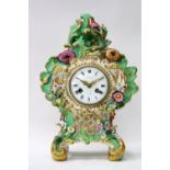 A COALPORT PORCELAIN MANTLE CLOCK c.1830 with polychrome decorated flower encrusted case, the