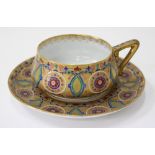 A 20TH CENTURY RUSSIAN ENAMELLED CUP AND SAUCER by N.C. Kyehelioba ( Kuznetsov)