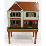 A MID 20TH CENTURY DOLL'S HOUSE 87cm wide x 75cm high, together with a small pine table