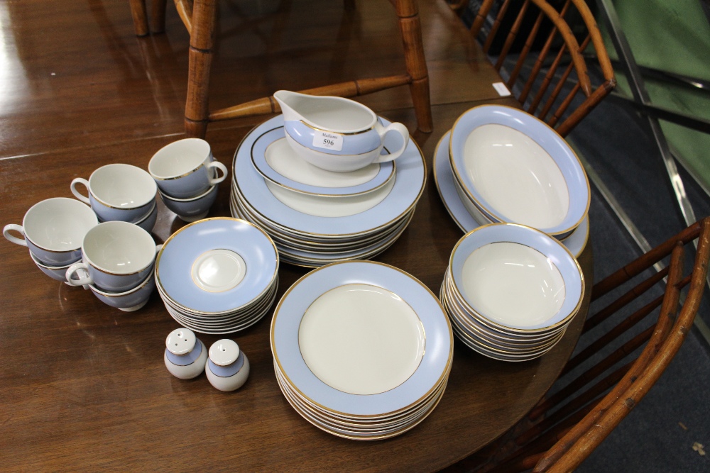 A ROYAL DOULTON DINNER SERVICE with gilt and powder blue decoration to include: dinner plates,