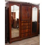 AN EDWARDIAN FLAME MAHOGANY TRIPLE WARDROBE with chevron inlay and mirror front doors, 200cm x 207cm