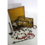 A BOX OF COSTUME JEWELLERY to include earrings, necklaces, brooches, bracelets, a late 19th /