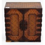 A LATE 19TH / EARLY 20TH CENTURY ORIENTAL PARQUETRY CABINET CHEST with two fielded panelled doors
