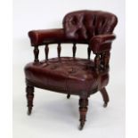 A LEATHER CAPTAIN'S CHAIR standing on turned tapering legs, terminating in porcelain casters, 81cm