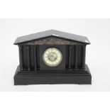 A 19TH CENTURY BLACK SLATE ARCHITECTURAL MANTLE CLOCK with white enamel dial and Arabic numerals,