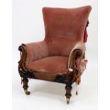 AN EARLY 19TH CENTURY WALNUT LIBRARY CHAIR with red or pink upholstery on turned tapering legs,