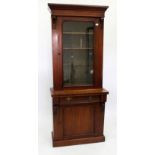 A VICTORIAN MAHOGANY BOOKCASE with glazed top, above a fielded panel door, 83cm wide