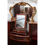 A SCROLLING GILT FRAMED WALL MIRROR 90cm wide together with an early Victorian mahogany swing toilet