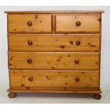 A LATE 20TH / EARLY 21ST CENTURY PINE TWO SHORT AND THREE LONG DRAWER CHEST standing on bun feet,