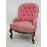 A VICTORIAN MAHOGANY AND PINK BUTTON UPHOLSTERED NURSING CHAIR on porcelain casters, 79cm high