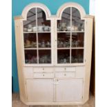 A LATE 19TH / EARLY 20TH CENTURY WHITE PAINTED GLAZED CABINET with arched panel doors above four