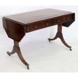 A 19TH CENTURY MAHOGANY LINE INLAID SOFA TABLE on turned stretcher, terminating in brass casters,