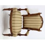 A VICTORIAN FRENCH STYLE WALNUT ARMCHAIR upholstered in striped brocade fabric, terminating in