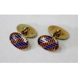 A PAIR OF SILVER GILT CUFFLINKS of oval form with red and blue enamel decoration