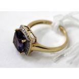 A 9 CARAT GOLD AMETHYST AND CHIP DIAMOND SET RING