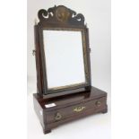 A GEORGE III MAHOGANY SWING DRESSING TABLE MIRROR of small proportions with fret carved top, brass