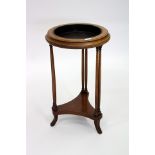 AN EMPIRE STYLE WALNUT PLANT STAND with ebonised tray standing on triform base, 69cm high