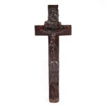 AN 18TH CENTURY CONTINENTAL CARVED FRUITWOOD CRUCIFIX the reverse decorated with instruments of