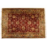 A MID TO LATE 20TH CENTURY PERSIAN YELLOW AND RED GROUND RUG with a banded border and foliate