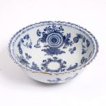 AN 18TH CENTURY ENGLISH DELFTWARE BOWL decorated in cobalt blue with flowers and with frill edge