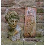 A PAINTED TERRACOTTA BUST after Michelangelo David, 48cm high together with a terracotta wall plaque