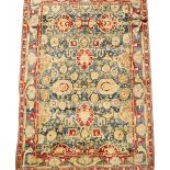 AN EARLY TO MID 20TH CENTURY INDIAN BLUE AND RED GROUND SMALL CARPET with a banded border and