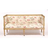 AN 18TH CENTURY FRENCH STYLE YELLOW STAINED BEECH FRAMED SMALL SOFA with carved and fluted outset