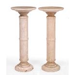 A NEAR PAIR OF TURNED MARBLE TORCHERES OR SCULPTURE STANDS with ring turned column and spreading