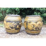 A PAIR OF CHINESE OVOID PLANTERS decorated in relief with dragons chasing a flaming pearl