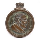 A 19TH CENTURY GILT METAL COMMEMORATIVE PLAQUE depicting the Duke of Wellington in profile and