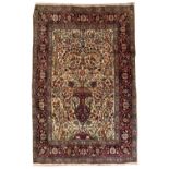 AN ISFAHAN RUG with a central urn motif, foliate vine decoration and a multiple banded border, 128cm